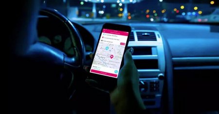 Woman navigating a map app inside a car